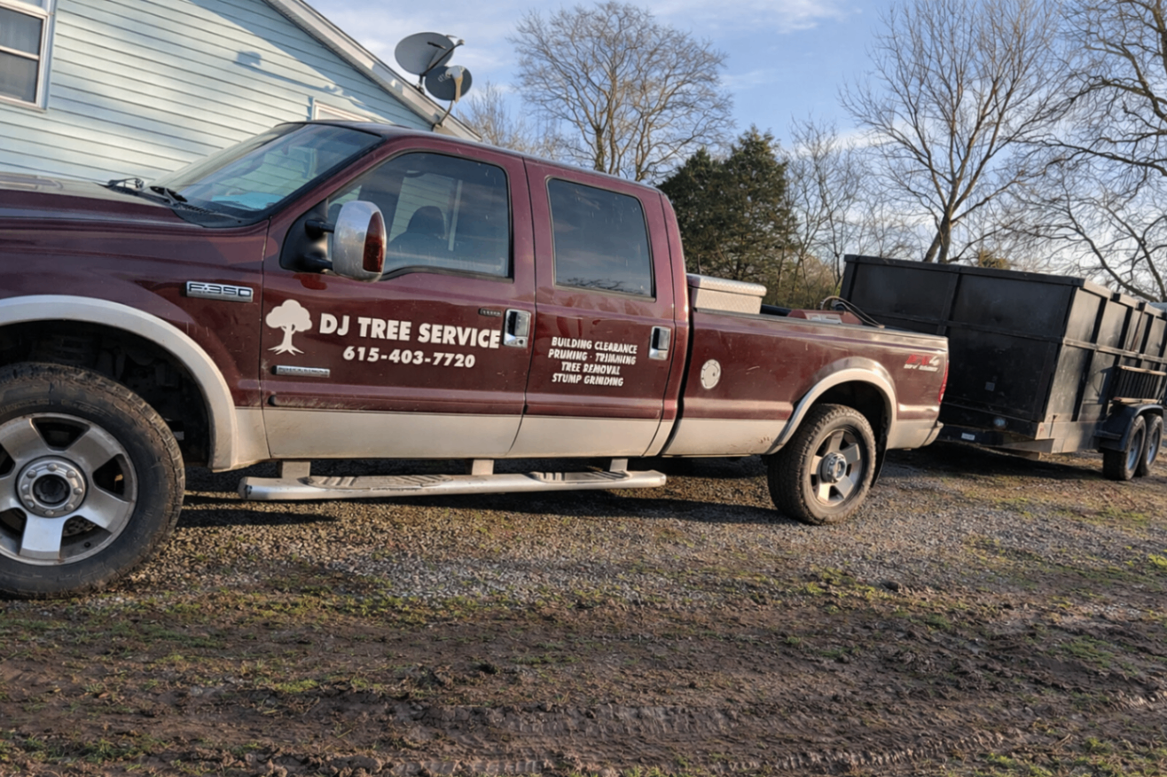 DJ Tree Service pickup truck towing a black trailer