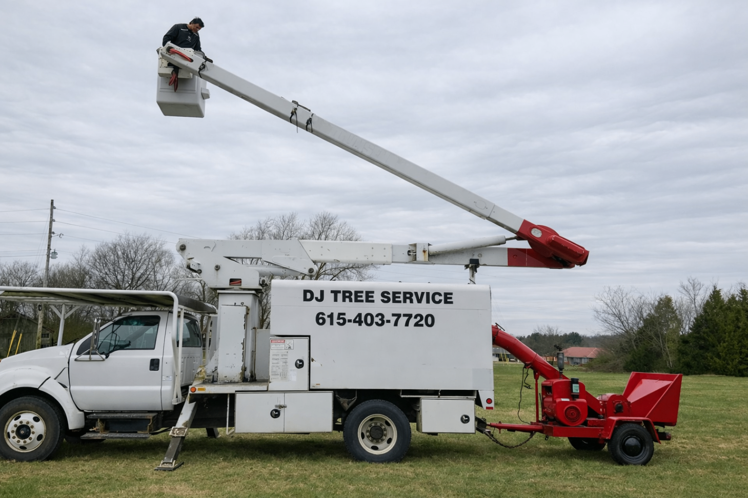 Aerial truck with elevated boom and worker in the bucket