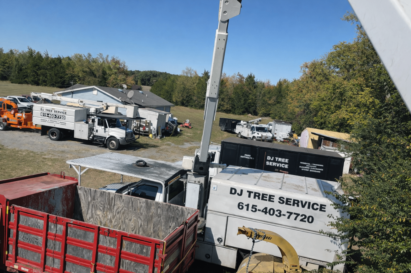 View from an elevated boom showing trucks, chip boxes and equipment in the yard